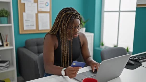 アフリカ系アメリカ人女性ビジネスワーカーショッピングとともにラップトップとクレジットカード見て動揺でオフィス — ストック動画