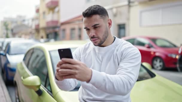 Young Hispanic Man Using Smartphone Sitting Car Street — Stock Video