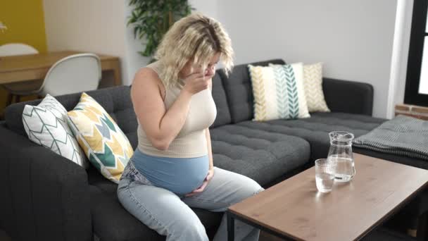 Νεαρή Έγκυος Γυναίκα Που Κάθεται Στον Καναπέ Και Υποφέρει Από — Αρχείο Βίντεο
