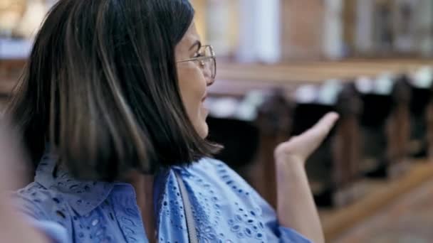 年轻美丽的惊慌失措的女人在圣卡尔博罗摩斯教堂进行视频通话 — 图库视频影像