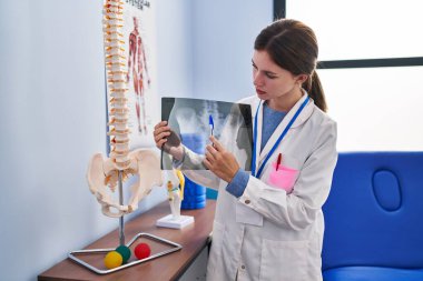 Rehabilitasyon kliniğinde ciddi yüzü olan genç sarışın fizyoterapist.