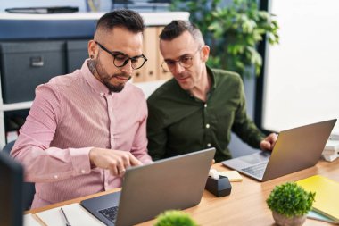 Two men business workers using laptop working at office