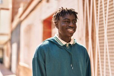 African american man smiling confident looking to the side at street