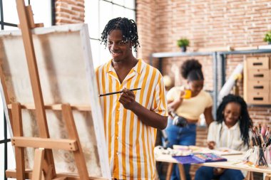 African american friends artists smiling confident drawing at art studio