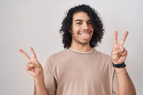 Hispanic Man Curly Hair Standing White Background Smiling Tongue Out — Stock Photo, Image