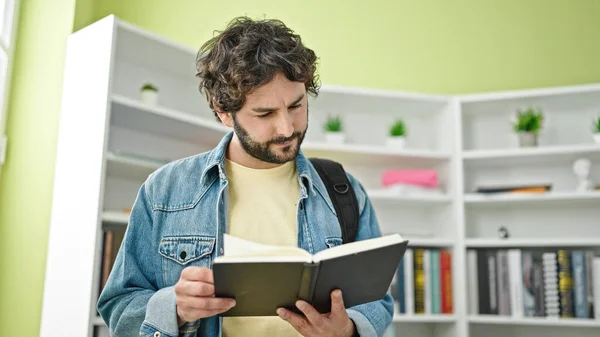 Young Hispanic Man Student Wearing Backpack Reading Book Library University — Stock Photo, Image