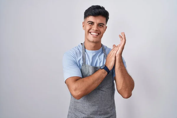 Hispanic Young Man Wearing Apron White Background Clapping Applauding Happy — Stok fotoğraf