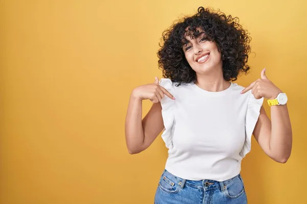年轻的中东女人站在黄色的背景上 面带微笑 自信而自信 用手指指着自己 自豪而快乐 — 图库照片