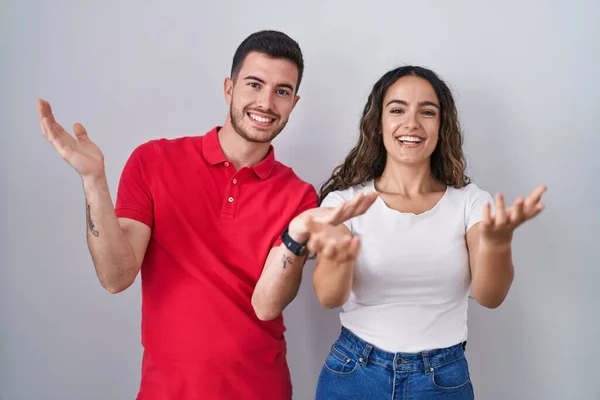 Jong Hispanic Paar Staan Geïsoleerde Achtergrond Glimlachend Vrolijk Aanbieden Van — Stockfoto