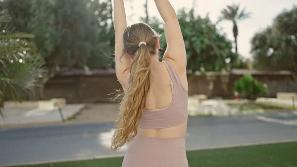 Spor Kıyafetleri Giyen Genç Sarışın Kadın Parkta Kollarını Esnetiyor — Stok fotoğraf