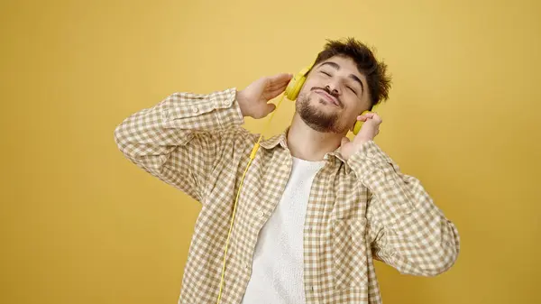 stock image Young arab man listening to music dancing over isolated yellow background