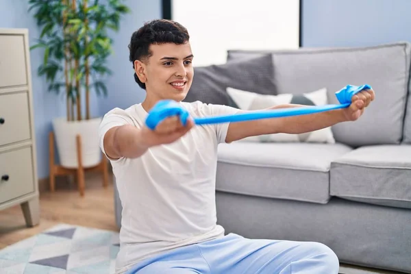 Young Non Binary Man Smiling Confident Using Elastic Band Training — Stock fotografie