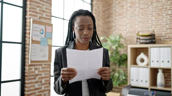 アフリカ系アメリカ人女性ビジネスワーカーオフィスで書類を読む — ストック写真