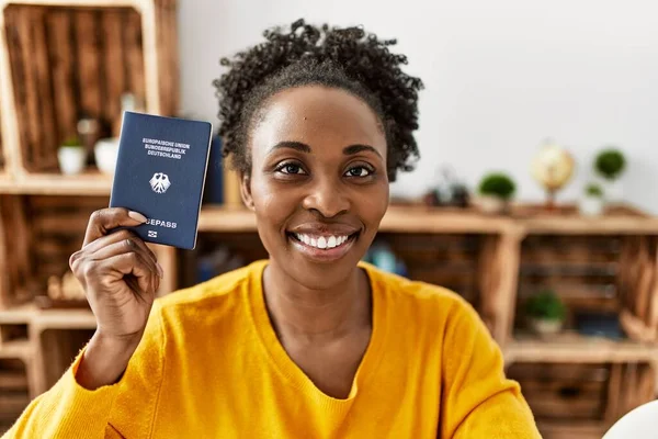 African American Woman Holding Deutchland Passport Sitting Table Home — Stockfoto