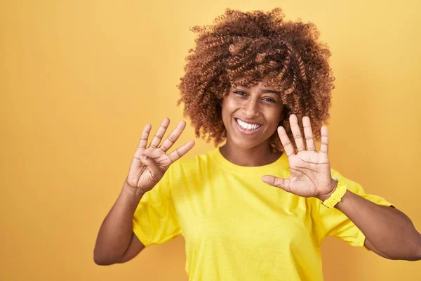 Jonge Spaanse Vrouw Met Krullend Haar Staande Gele Achtergrond Tonen — Stockfoto