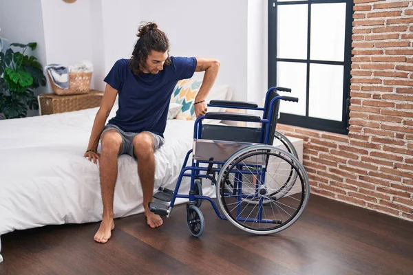 Young Hispanic Man Disabled Trying Sit Wheelchair Bedroom — Photo