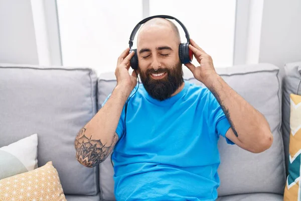 Young Bald Man Listening Music Sitting Sofa Home — Foto de Stock