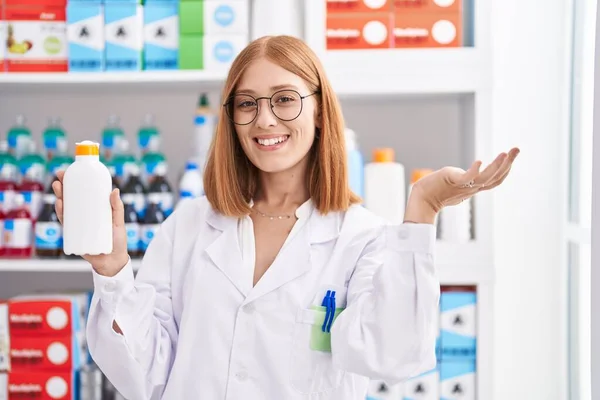 Young Redhead Woman Working Pharmacy Drugstore Holding Sun Screen Celebrating — Stock Photo, Image