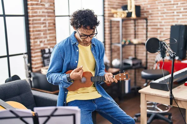 stock image Young hispanic man musician playing ukulele at music studio