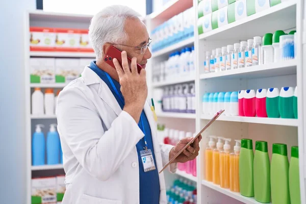 Middle Age Grey Haired Man Pharmacist Talking Smartphone Reading Document — Stock Photo, Image