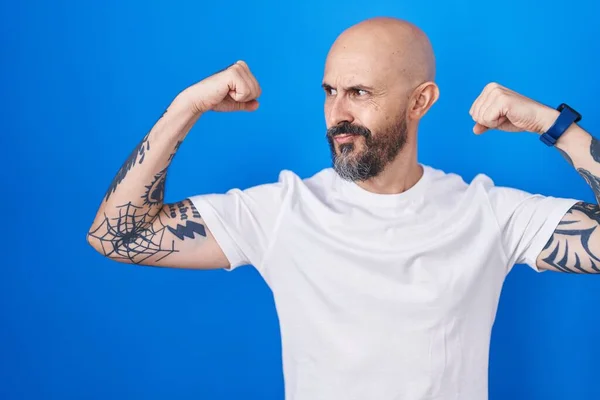 Hispanic Man Tattoos Standing Blue Background Showing Arms Muscles Smiling — Stockfoto