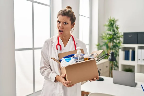 Young Doctor Woman Holding Box Medical Items Shock Face Looking — Stock Photo, Image