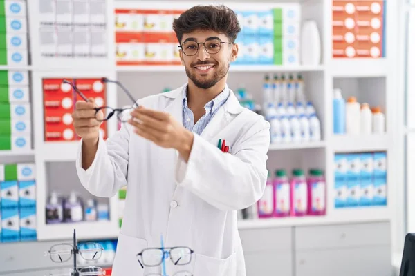Young Arab Man Pharmacist Smiling Confident Holding Glasses Pharmacy — 스톡 사진
