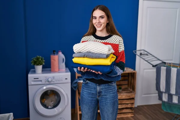 Young Hispanic Girl Holding Clean Laundry Smiling Happy Cool Smile — Stock Photo, Image