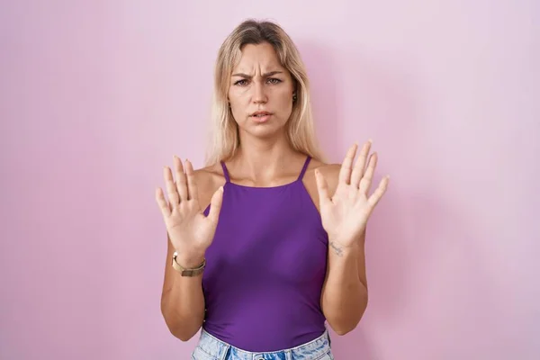 Young Blonde Woman Standing Pink Background Moving Away Hands Palms — 图库照片