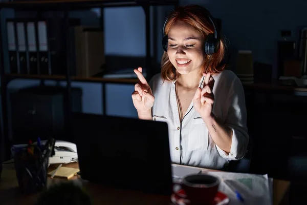 Young Caucasian Woman Working Office Night Gesturing Finger Crossed Smiling —  Fotos de Stock