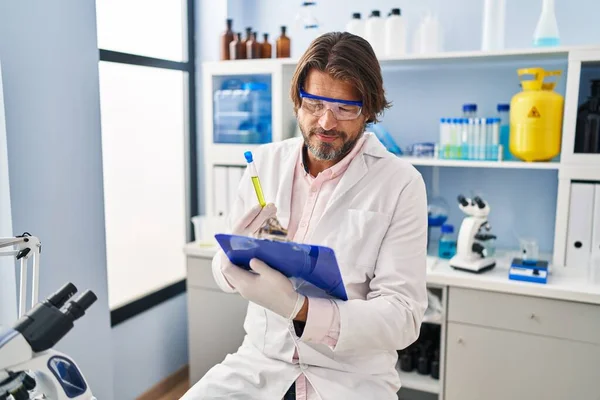 Middle Age Man Scientist Holding Test Tube Reading Document Laboratory — Stockfoto