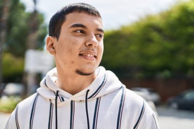 Sokakta kendine güvenen genç adam gülümsüyor