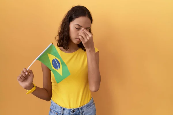 Young Hispanic Woman Holding Brazil Flag Tired Rubbing Nose Eyes — Stock Photo, Image
