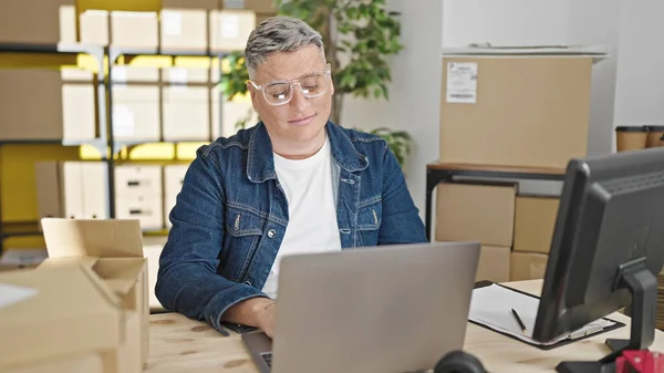 stock image Young caucasian man ecommerce business worker using laptop smiling at office