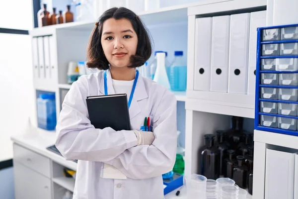 Young Hispanic Woman Working Scientist Laboratory Relaxed Serious Expression Face — Zdjęcie stockowe