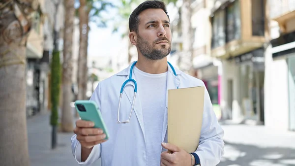 Junger Hispanischer Arzt Hält Arztbericht Mit Smartphone Auf Der Straße — Stockfoto