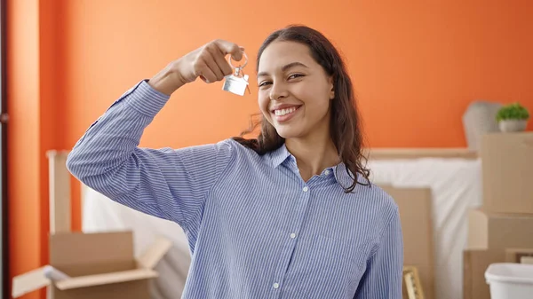 stock image Young beautiful hispanic woman smiling confident holding new house keys at new home