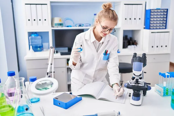 Young Blonde Woman Scientist Writing Notebook Holding Test Tube Laboratory — Stock Photo, Image