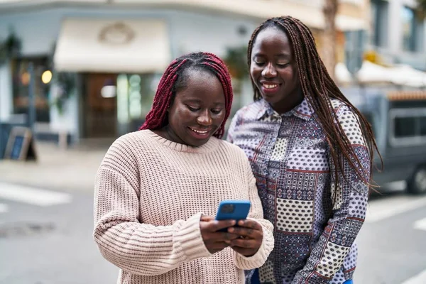 African American Women Friends Smiling Confident Using Smartphone Street — 图库照片