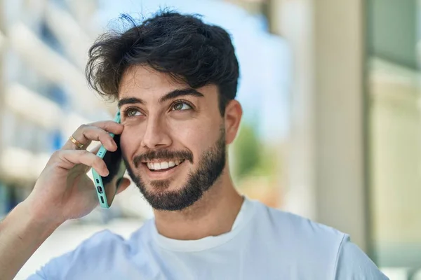 Stock image Young hispanic man smiling confident talking on the smartphone at street