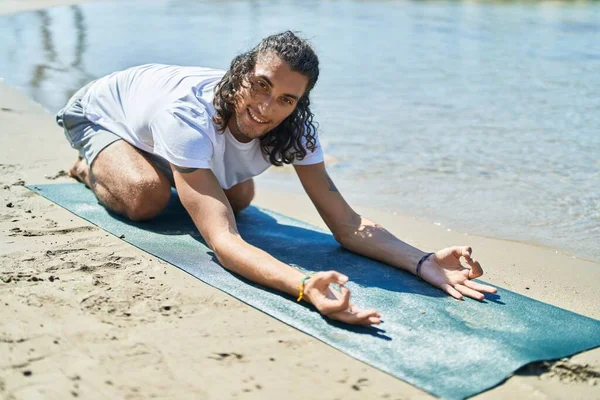 Young Hispanic Man Doing Yoga Exercise Sitting Sand Beach —  Fotos de Stock