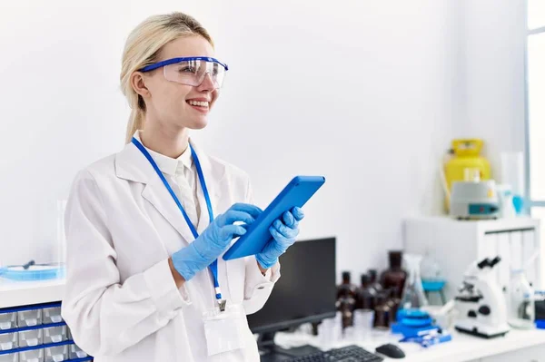 Young Blonde Woman Scientist Using Touchpad Smiling Laboratory — ストック写真