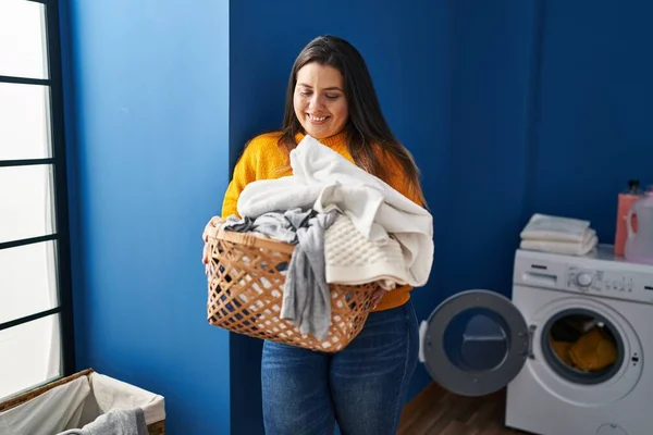 Young Beautiful Size Woman Smiling Confident Holding Basket Clothes Laundry — Stok fotoğraf