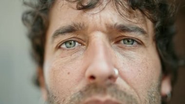 Sokakta ciddi bir ifadeyle duran İspanyol genç adam.