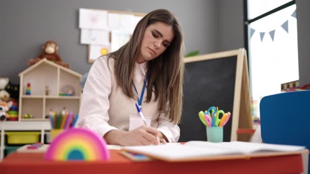 Young Beautiful Hispanic Woman Working Teacher Writing Kindergarten — Videoclip de stoc