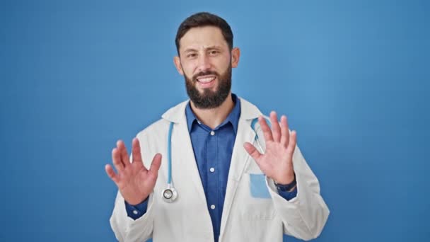 Young Hispanic Man Doctor Standing Serious Expression Doing Calm Gesture — Stock Video