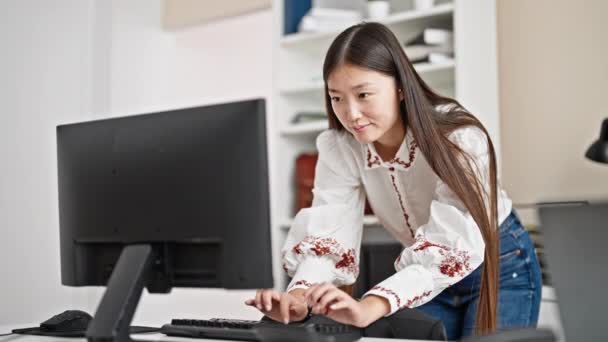 オフィスに立っているコンピュータを使用して若い中国の女性ビジネスワーカー — ストック動画