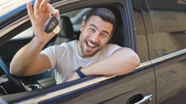 Sokakta yeni arabanın anahtarını tutan İspanyol asıllı genç adam.