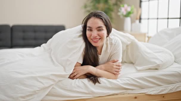 Young Beautiful Hispanic Woman Lying Bed Covering Bedsheet Bedroom — Stockvideo