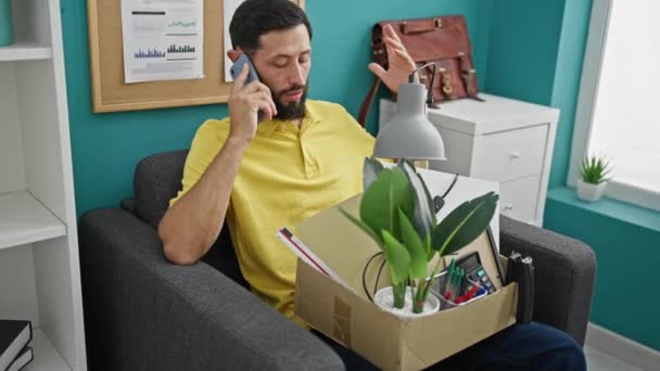 Young Hispanic Man Being Fired Sitting Sofa Talking Smartphone Office — Stock Video